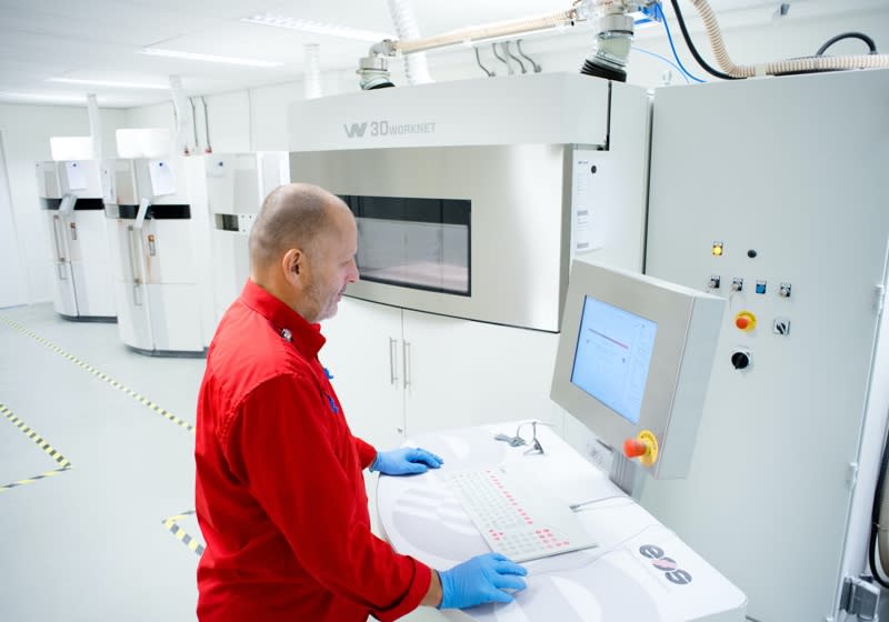 Commercial additive manufacturing Man working with a 3D printer